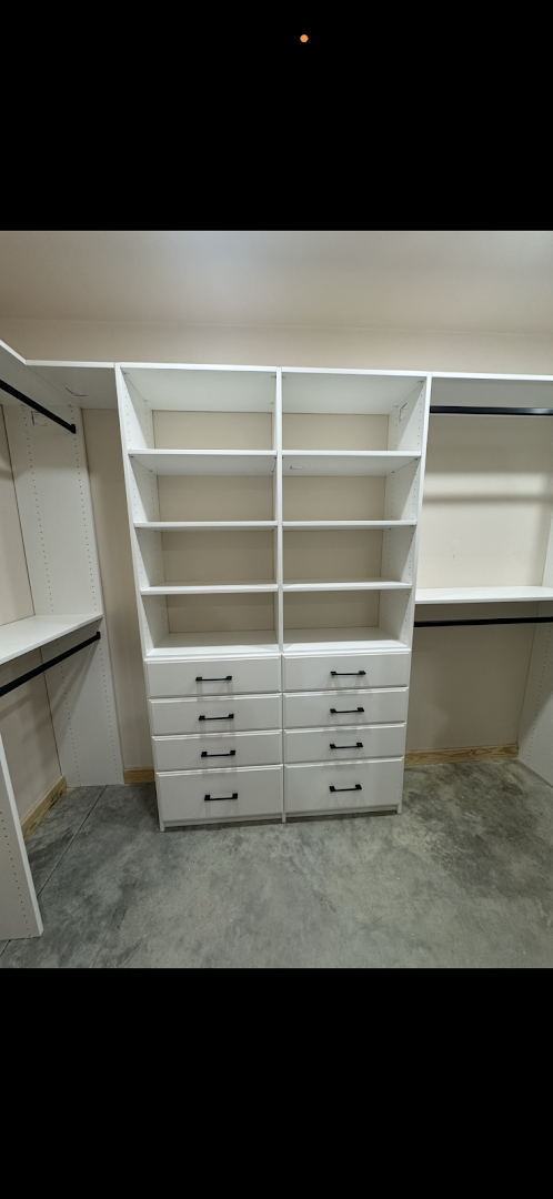 Custom white closet system with open shelving and stacked drawers