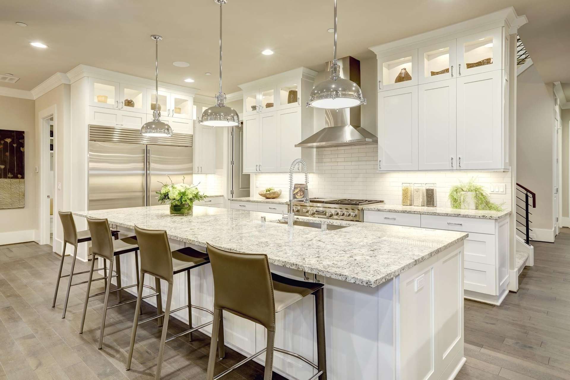 Spacious modern kitchen with white cabinetry and a large island